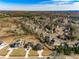 Overhead view showcasing a neighborhood with modern homes, mature trees, and various backyard amenities in a suburban setting at 2551 Kilgore Rd, Buford, GA 30519