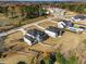 An aerial shot of two houses featuring a shared driveway, expansive lawns, and neighboring houses, pool and trees at 2551 Kilgore Rd, Buford, GA 30519