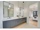 Contemporary bathroom with double vanity, pendant lighting, and doorway to bedroom at 2551 Kilgore Rd, Buford, GA 30519