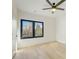 Minimalist bedroom featuring light hardwood floors and a large window with wooded views at 2551 Kilgore Rd, Buford, GA 30519