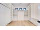 Spacious walk-in closet with custom shelving and hardwood floors at 2551 Kilgore Rd, Buford, GA 30519