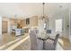 Open concept dining room and kitchen area with modern light fixtures and neutral color palette at 2551 Kilgore Rd, Buford, GA 30519