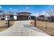 Long, gated driveway leading to a modern two-story home with a contemporary design and attached garages at 2551 Kilgore Rd, Buford, GA 30519