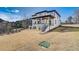 Exterior of the home showing the back of the house with a porch, patio, and stairs at 2551 Kilgore Rd, Buford, GA 30519
