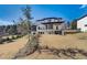 Back exterior of the home featuring a large, gently sloping yard and covered porch at 2551 Kilgore Rd, Buford, GA 30519