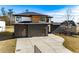 Home exterior view featuring a modern design, large driveway, and three-car garage at 2551 Kilgore Rd, Buford, GA 30519