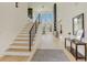 Bright foyer with hardwood floors, modern staircase, and soaring ceilings at 2551 Kilgore Rd, Buford, GA 30519
