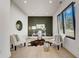 Bright home office features a modern desk, olive-colored accent wall, and light-colored wood floors at 2551 Kilgore Rd, Buford, GA 30519