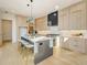 Kitchen featuring light wood cabinets, sleek stainless steel appliances, and a center island with seating at 2551 Kilgore Rd, Buford, GA 30519