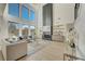 Open-concept living room with soaring ceilings, large windows, and modern fireplace at 2551 Kilgore Rd, Buford, GA 30519