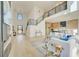 Open floor plan featuring a living room with staircase, large windows, and views into the modern kitchen at 2551 Kilgore Rd, Buford, GA 30519