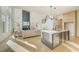 Open floor plan with seamless flow between the kitchen and the bright living room with modern finishes at 2551 Kilgore Rd, Buford, GA 30519
