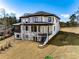 Beautiful rear exterior featuring spacious balcony, lush green lawn, and modern design at 2551 Kilgore Rd, Buford, GA 30519