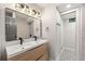 Bathroom boasts double sink vanity, modern lighting, and tiled shower near patterned flooring at 3430 Rocky Springs Ct, Marietta, GA 30062