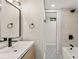 Bathroom with black hardware, stylish mirror, and patterned tile flooring leading to bathtub at 3430 Rocky Springs Ct, Marietta, GA 30062