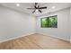 Bright bedroom featuring a ceiling fan, window, and light wood-look flooring at 3430 Rocky Springs Ct, Marietta, GA 30062