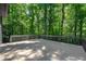 Large deck provides views of the lush, surrounding woodland setting at 3430 Rocky Springs Ct, Marietta, GA 30062