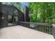 Expansive deck with gray railings offers views of the home's unique architecture at 3430 Rocky Springs Ct, Marietta, GA 30062