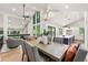 Bright dining area featuring a modern chandelier, kitchen view, and lots of natural light from large windows at 3430 Rocky Springs Ct, Marietta, GA 30062