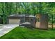 Contemporary-style home with a well-manicured lawn, attached garage and modern architectural details at 3430 Rocky Springs Ct, Marietta, GA 30062