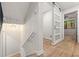 Hallway with stairs, modern lighting, and access to a bedroom with view of the trees at 3430 Rocky Springs Ct, Marietta, GA 30062