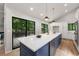 Bright open kitchen featuring a large island with bar seating and a sliding glass door to the deck at 3430 Rocky Springs Ct, Marietta, GA 30062