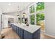 Bright kitchen boasts a large center island, stainless appliances, and floor-to-ceiling window views at 3430 Rocky Springs Ct, Marietta, GA 30062