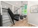 Upstairs landing featuring a living space with modern decor, hardwood floors, and large windows at 3430 Rocky Springs Ct, Marietta, GA 30062