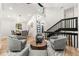Open concept living room boasts modern decor, hardwood floors, and stairs to the upper level at 3430 Rocky Springs Ct, Marietta, GA 30062