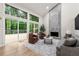 A bright living room boasts a modern fireplace, large windows, and access to an outdoor deck at 3430 Rocky Springs Ct, Marietta, GA 30062