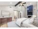 Spacious main bedroom suite with modern barn door, accent wall fireplace, and ceiling fan at 3430 Rocky Springs Ct, Marietta, GA 30062