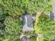 Stunning aerial view of home showcasing lush greenery, landscaped yard, and quiet neighborhood at 5190 Beech Forest Sw Dr, Lilburn, GA 30047