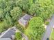 Stunning aerial view of home showcasing lush greenery, landscaped yard, and quiet neighborhood at 5190 Beech Forest Sw Dr, Lilburn, GA 30047