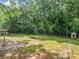 Secluded backyard featuring lush greenery and a dog house perfect for relaxation and recreation at 5190 Beech Forest Sw Dr, Lilburn, GA 30047