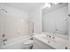 Bathroom with bathtub, shower, tile walls, and single sink vanity at 5190 Beech Forest Sw Dr, Lilburn, GA 30047