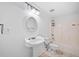 Bathroom equipped with a white sink, toilet, and shower combo, offering comfort and convenience at 5190 Beech Forest Sw Dr, Lilburn, GA 30047