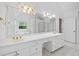 Bright bathroom with a double sink vanity, granite counters, tile floors and tub in background at 5190 Beech Forest Sw Dr, Lilburn, GA 30047
