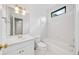 Bright bathroom featuring a tub with shower, vanity with a sink, and a mirrored wall cabinet at 5190 Beech Forest Sw Dr, Lilburn, GA 30047
