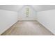Bedroom with neutral carpet, white walls, trim detail and a window with backyard view at 5190 Beech Forest Sw Dr, Lilburn, GA 30047