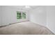 Bright bedroom features neutral carpet, white walls, a ceiling fan and a large window at 5190 Beech Forest Sw Dr, Lilburn, GA 30047
