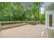 Expansive wooden deck surrounded by lush greenery and mature trees, creating a serene outdoor space at 5190 Beech Forest Sw Dr, Lilburn, GA 30047