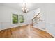 Dining room features hardwood flooring, white wainscoting, and a chandelier at 5190 Beech Forest Sw Dr, Lilburn, GA 30047