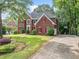 Beautiful brick home with red shutters, a manicured lawn, and a spacious driveway in a desirable neighborhood at 5190 Beech Forest Sw Dr, Lilburn, GA 30047