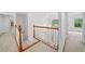 Upstairs hallway with hardwood railing, and carpet leading to bedrooms at 5190 Beech Forest Sw Dr, Lilburn, GA 30047