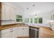 Bright kitchen featuring granite countertops, stainless steel appliances, and a view to the breakfast nook at 5190 Beech Forest Sw Dr, Lilburn, GA 30047