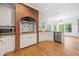 Bright kitchen featuring white cabinets, granite countertops, and a brick alcove stove at 5190 Beech Forest Sw Dr, Lilburn, GA 30047