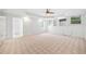 Spacious living room featuring a fan, built-in shelving, windows, and tiled flooring entrance at 5190 Beech Forest Sw Dr, Lilburn, GA 30047