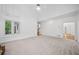 Bright, carpeted living room with large windows, vaulted ceiling, and access to other rooms at 5190 Beech Forest Sw Dr, Lilburn, GA 30047