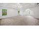 Spacious main bedroom with neutral carpet, ceiling fan, tray ceiling and abundant natural light at 5190 Beech Forest Sw Dr, Lilburn, GA 30047