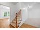 Staircase with hardwood steps, carpet runner, and wooden railing, connecting the different levels of the home at 5190 Beech Forest Sw Dr, Lilburn, GA 30047